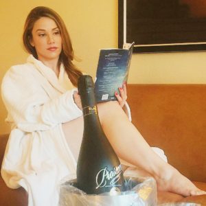 Girl Reading a book and drinking champagne