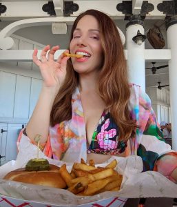 woman-eating-burger-and-fries